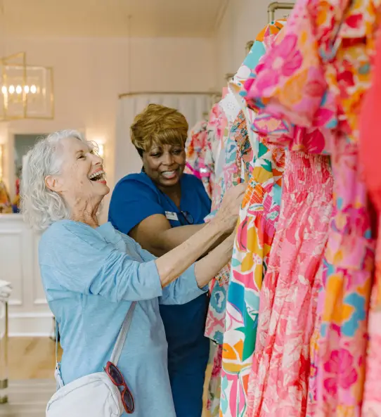 A caregiver and senior client enjoying a colorful activity