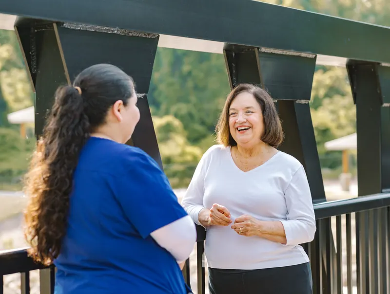 DayBreak caregiver and client reviewing a book together