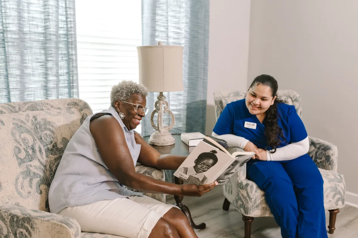 DayBreak caregiver sharing a familiar activity with an older adult in a care setting