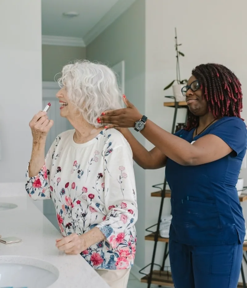 DayBreak caregiver helping an older adult with personal grooming at home