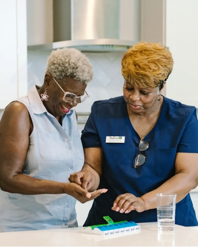 DayBreak caregiver helping an older adult with a daily medication routine at home