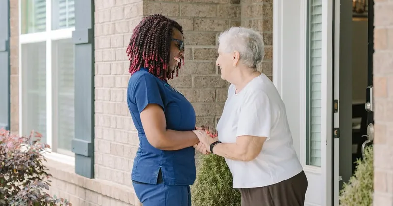 DayBreak caregiver greeting and supporting an older adult at home